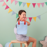 light blue insulated lunch bag with aluminium lining and contrasting bright red handles