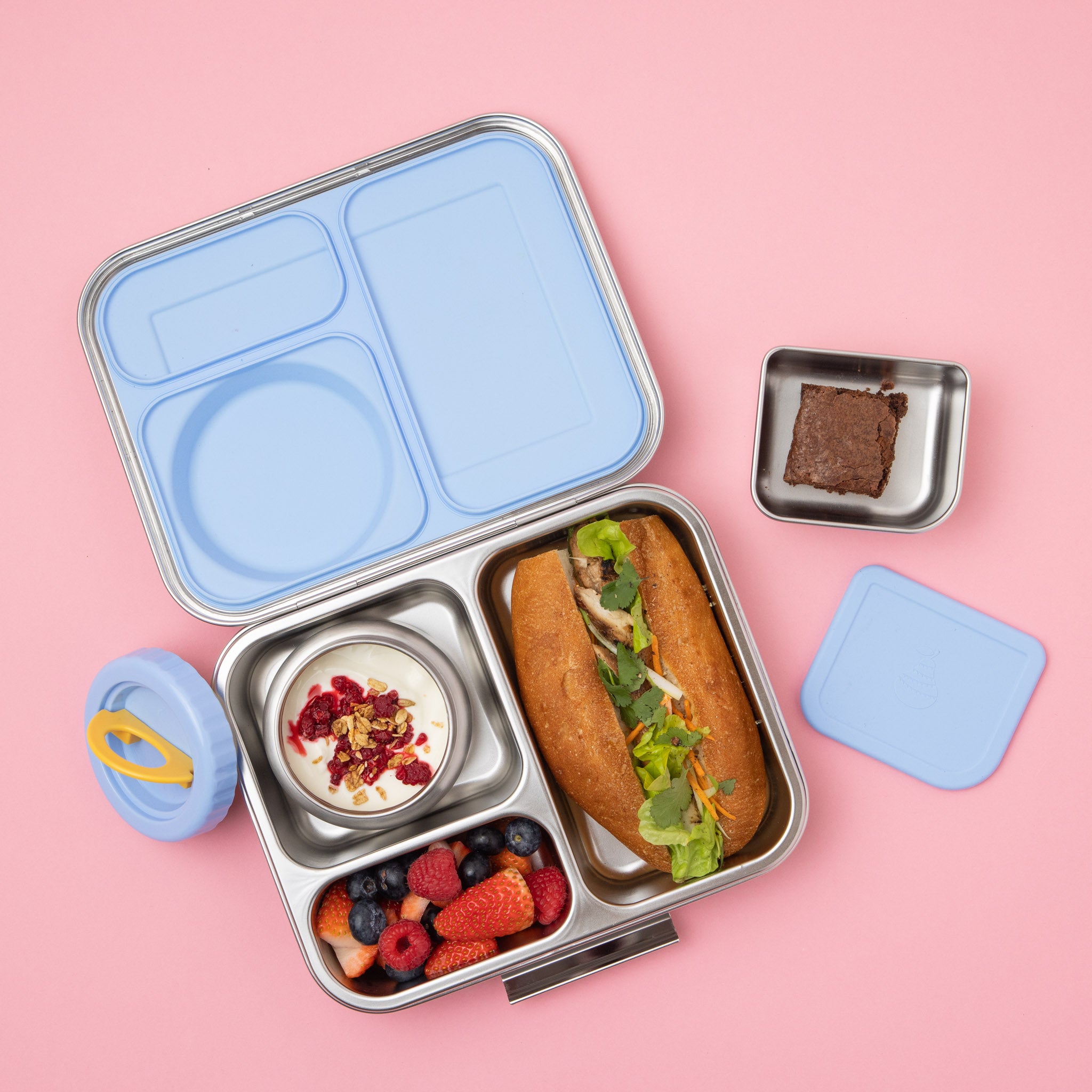 stainless steel 3 compartment bento box with light blue silicone seal and insulated food jar plus snack container filled with food 